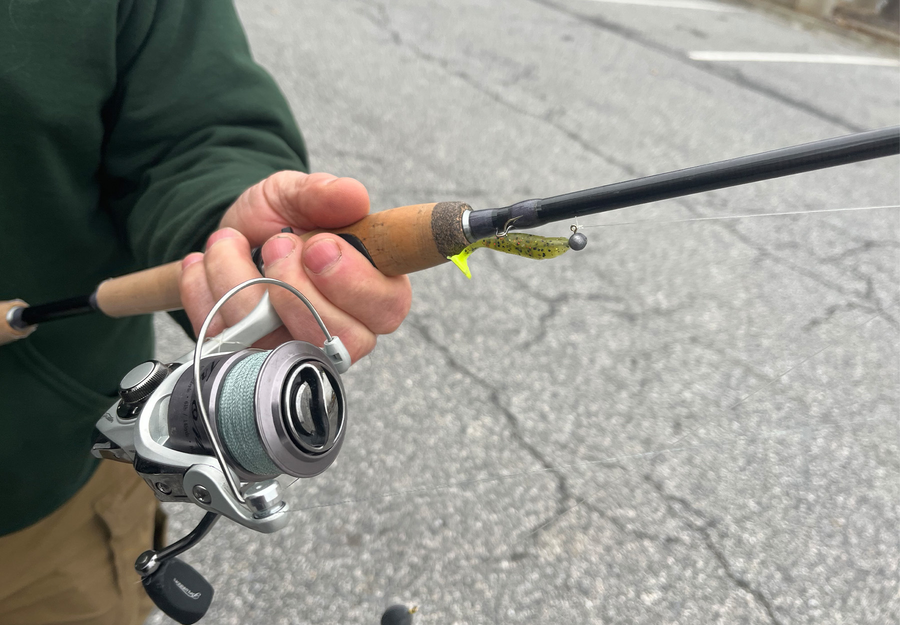 A spinning rod rigged with a soft plastic lure.