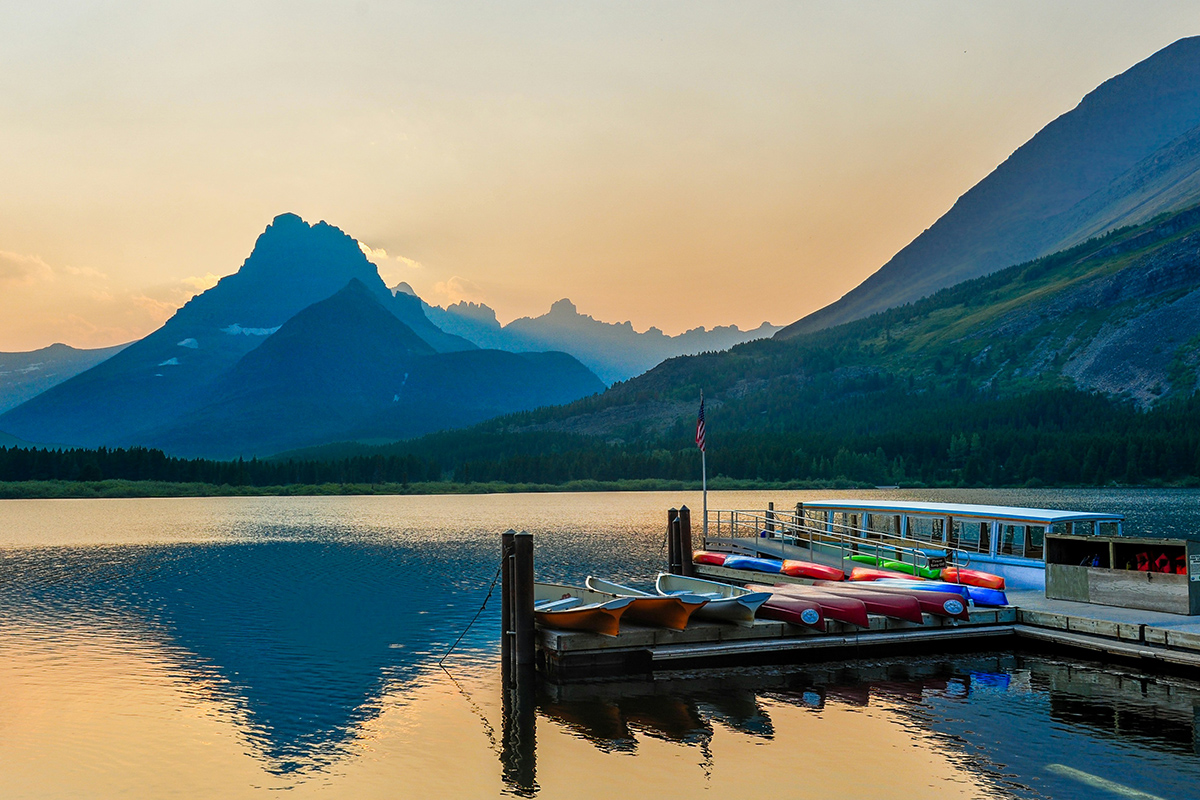 Colorful canoes on a lake dock.