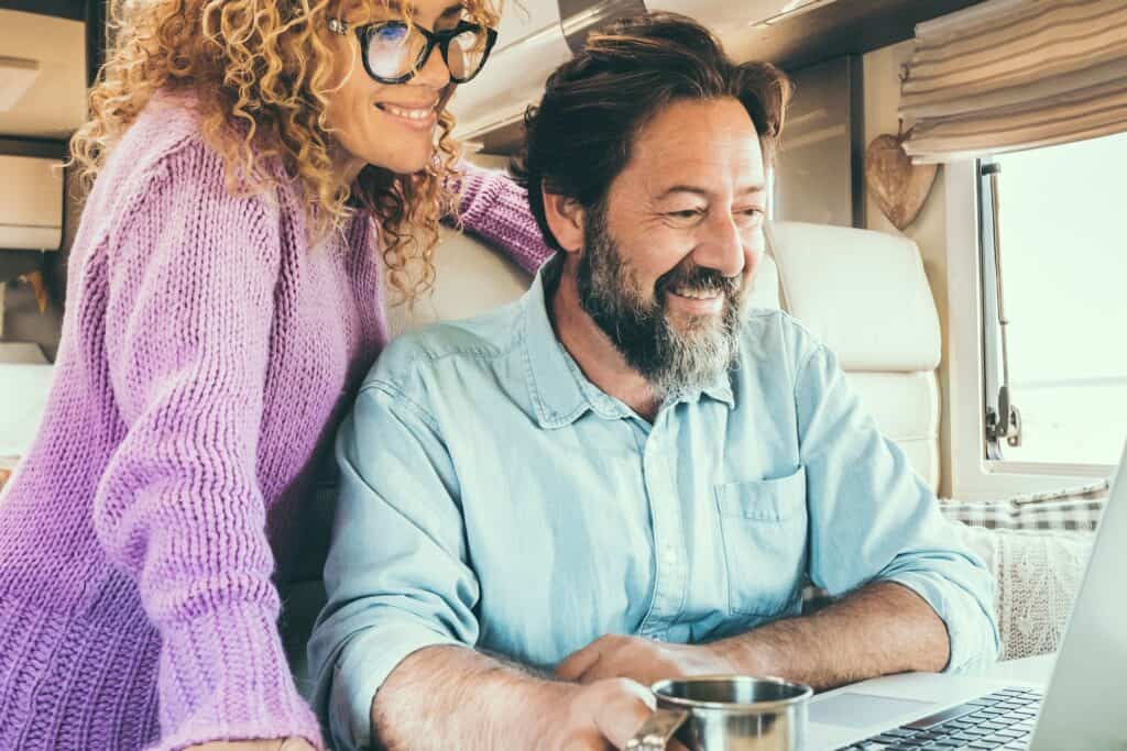 Couple using Smart RV Technology on their laptop