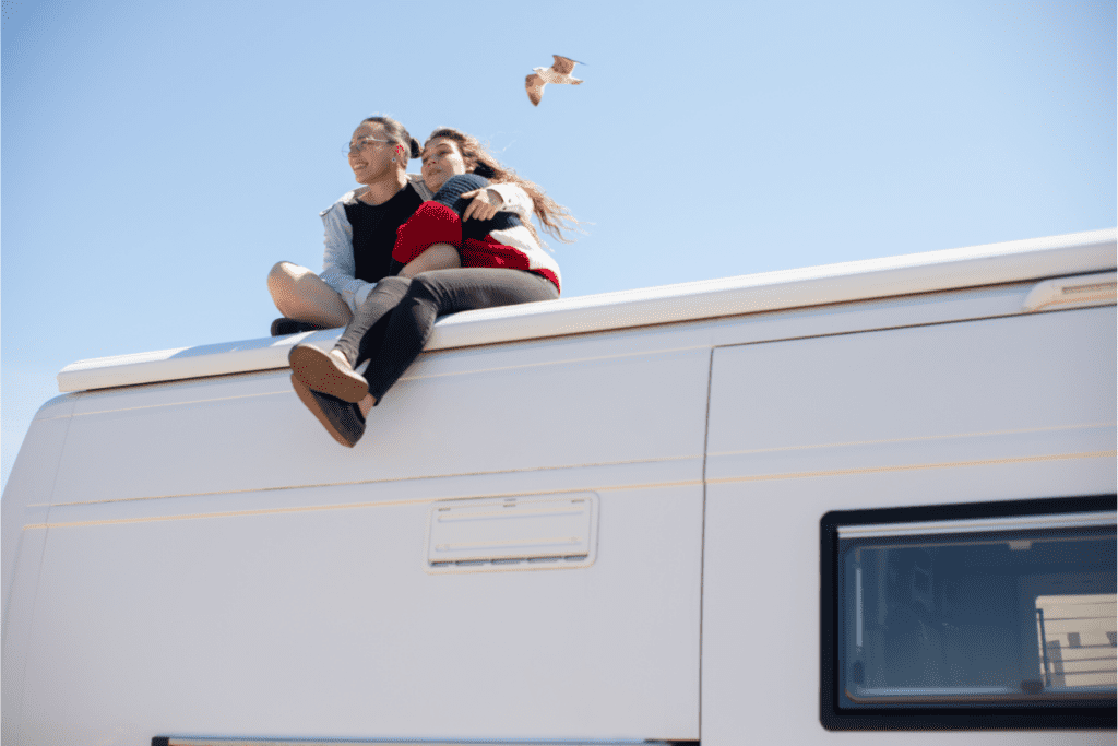 Two people sitting on top of their RV