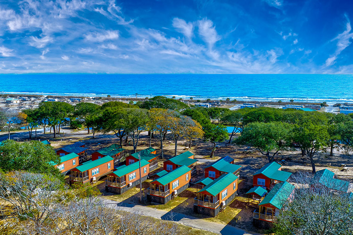 Aerial shots of cabins with coast in background.