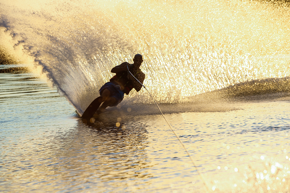 Waterskier generates a curtain of water.