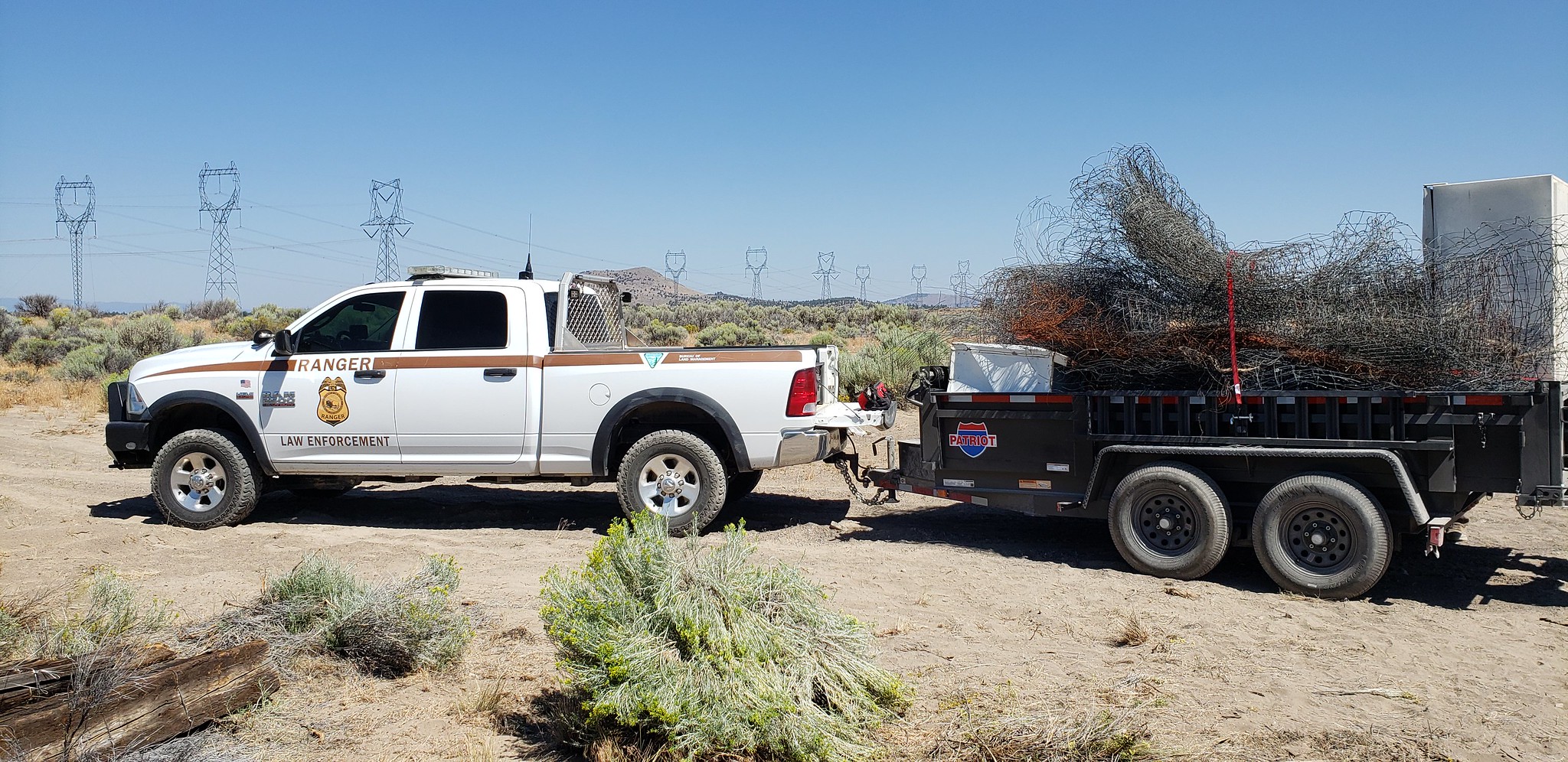 A BLM truck removes trash from federal land.