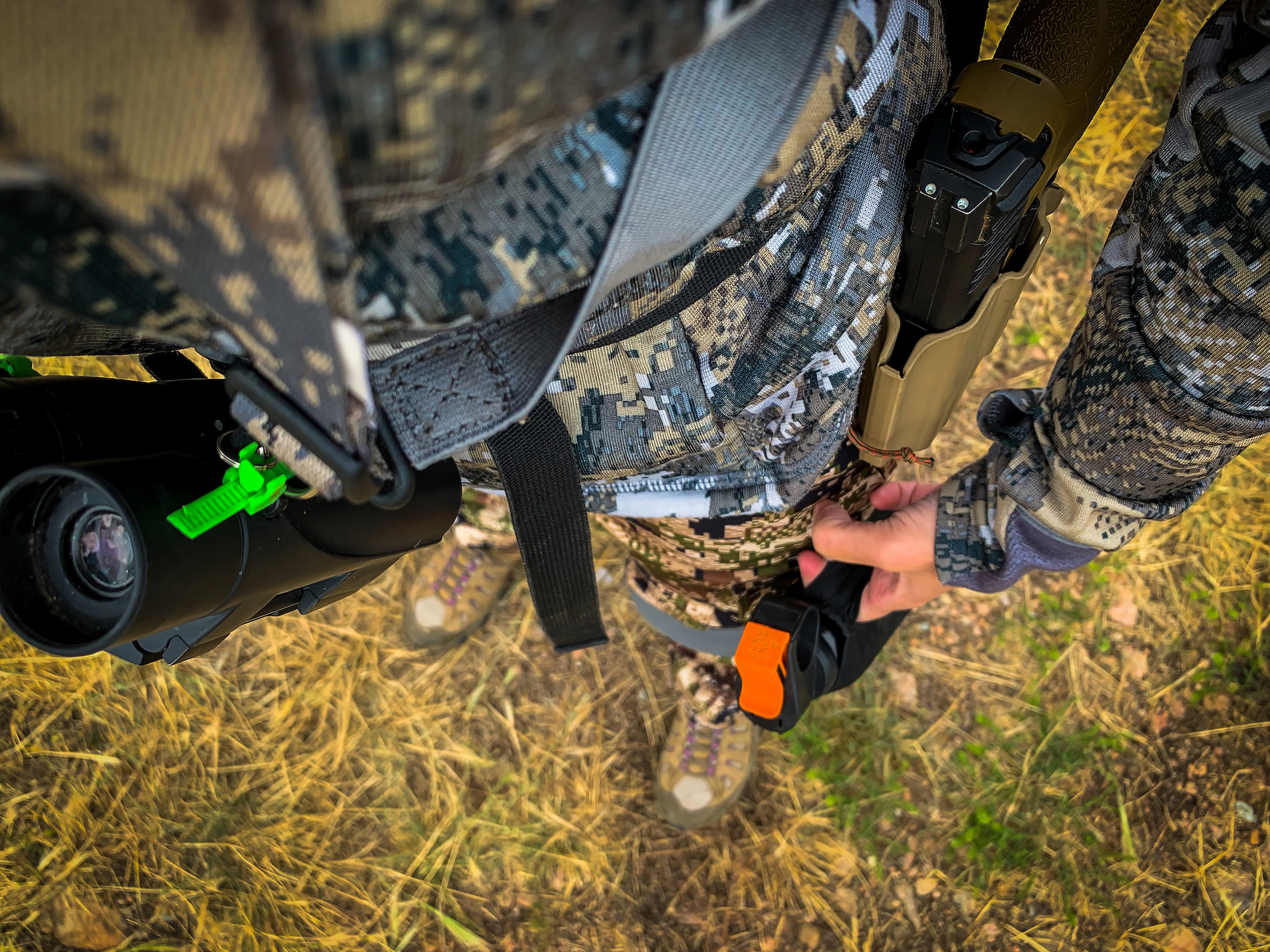 a hunter carries a sidearm along with bear spray