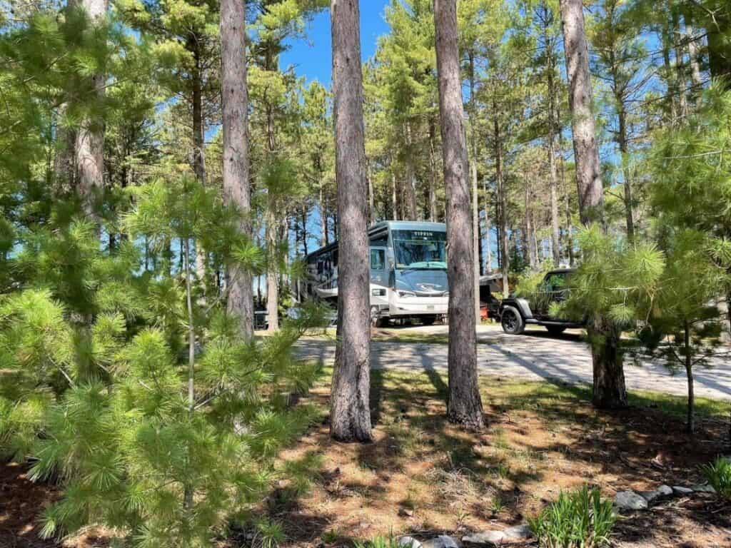 A motorhome and a dinghy vehicle at Scheffel's Hideaway Campground.