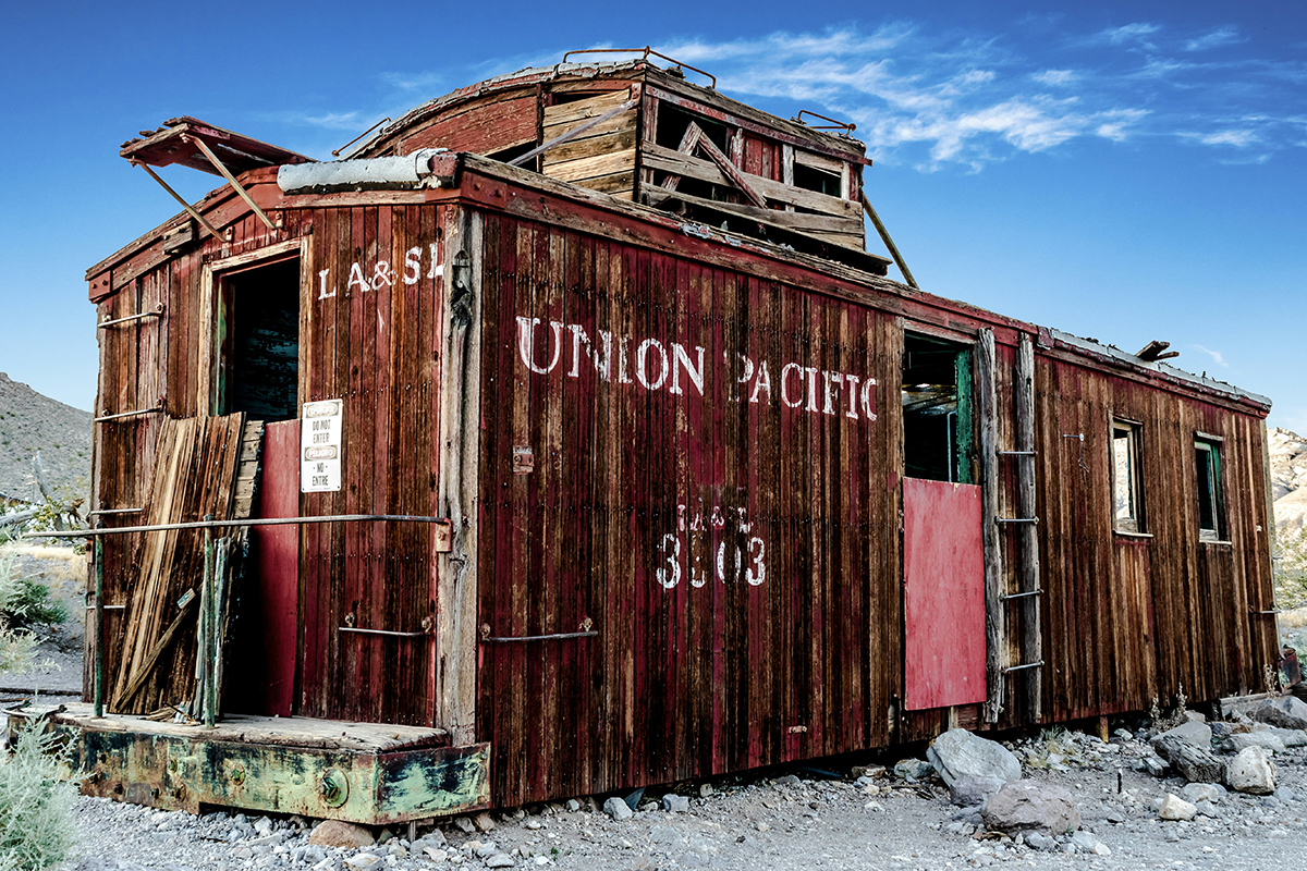 Rotting wooden rail car that is similar to a historic site.