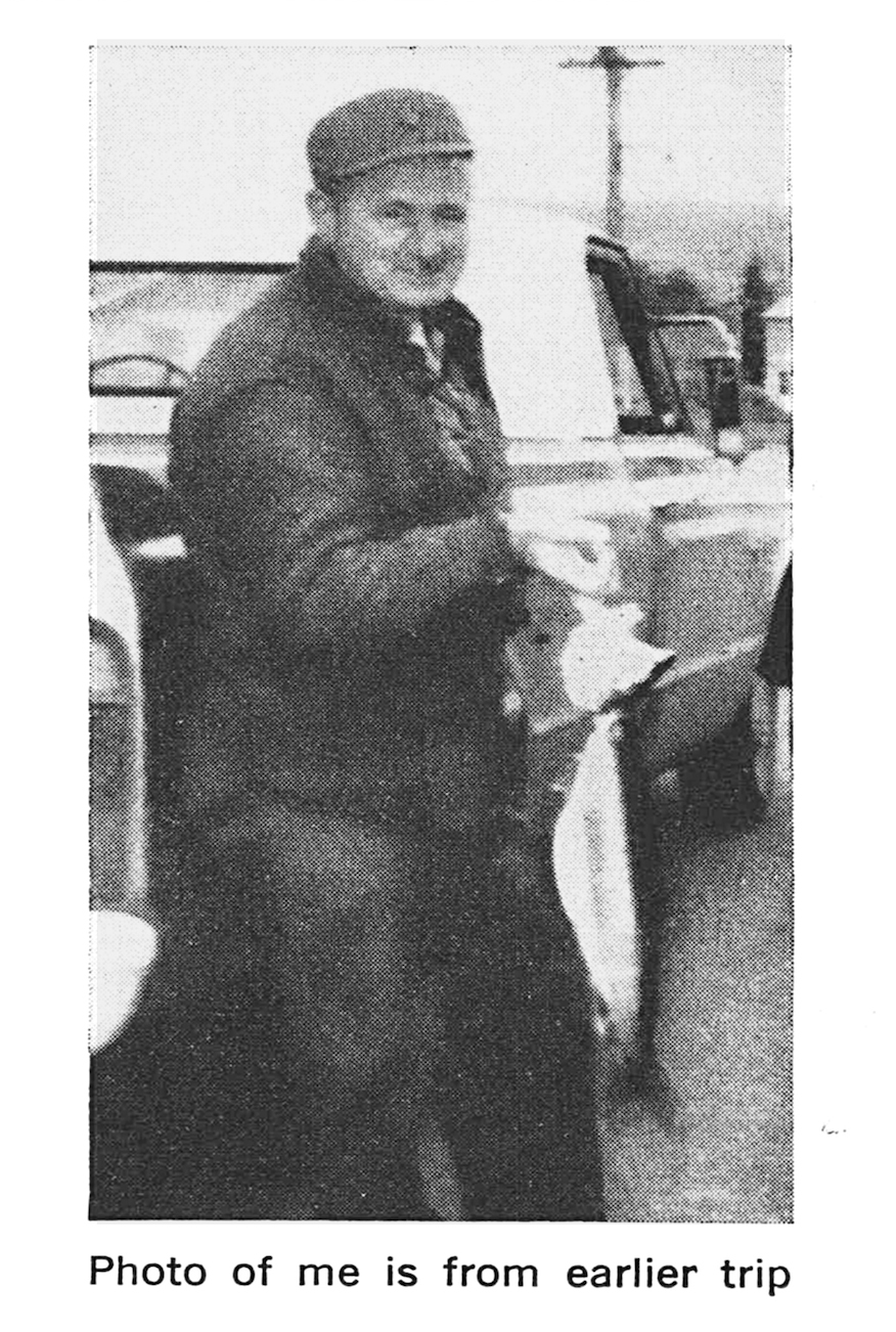 Fisherman Robert E. Houle holds up a fish in an old black and white photo