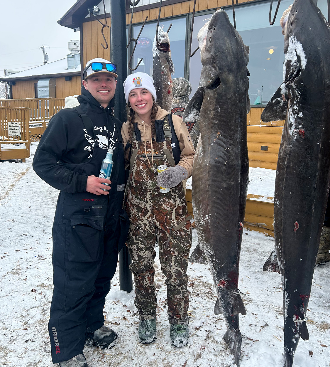 Two Wisconsin anglers stand next to harvested lake sturgeon.