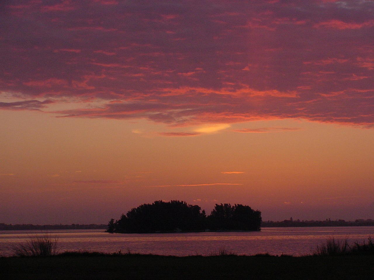 Lone Island against sunset sky during.