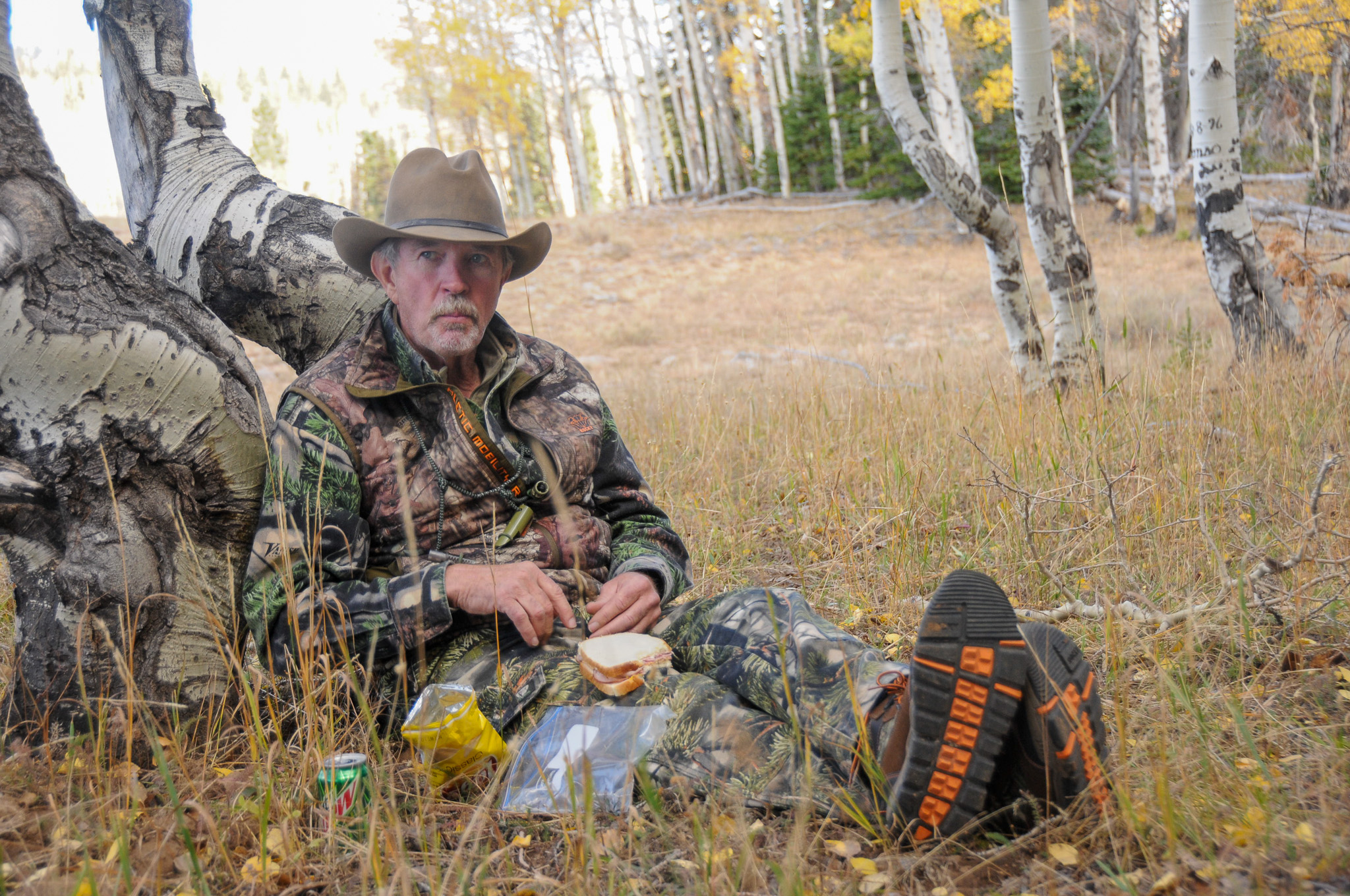 Wayne Carlton eats a sack lunch in the elk woods