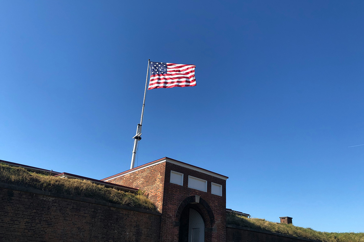 American flag from 1812 waves above a fortification in the Atlantic States.