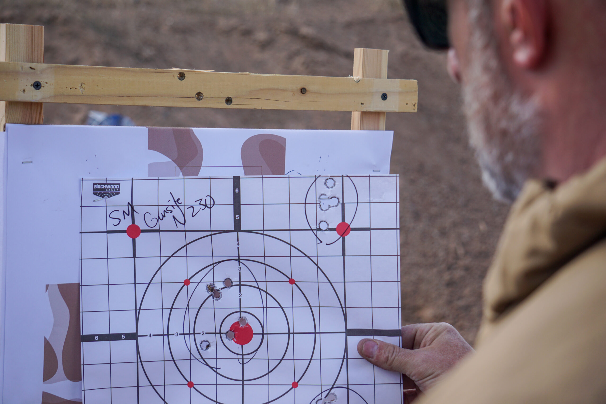 Inspecting targets shot by the best 1911