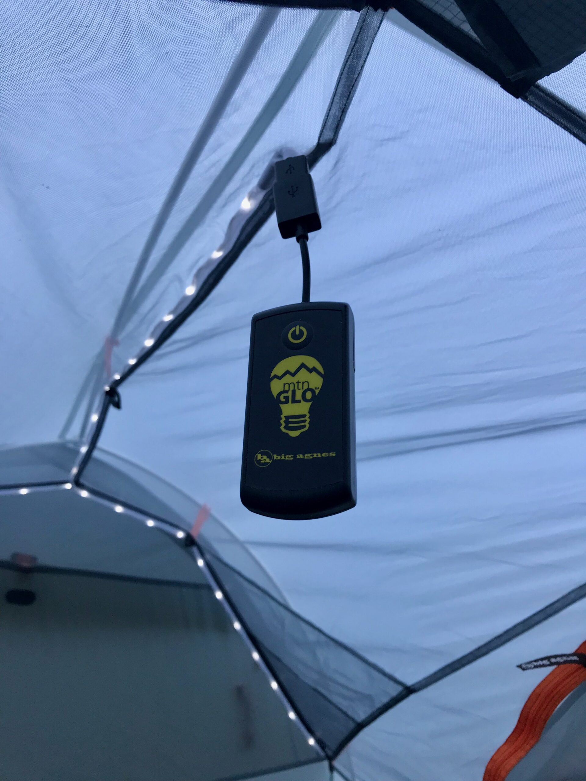 Use a string light camping gadget to illuminate a tent. 