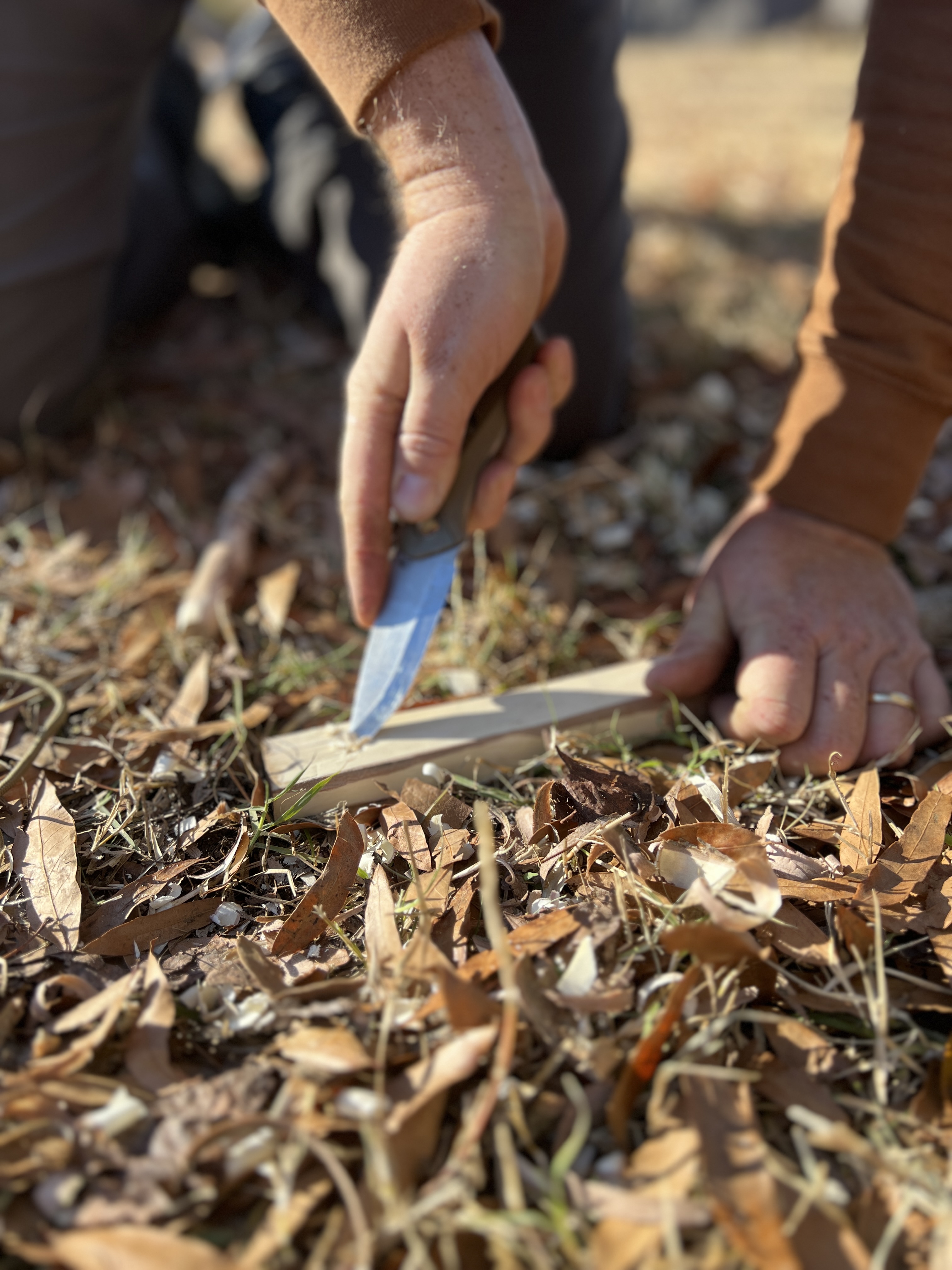 Using a survival knife to create a fire board