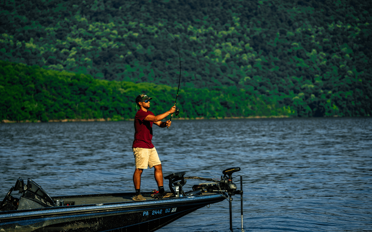 two hands on the rod while casting a spinning reel