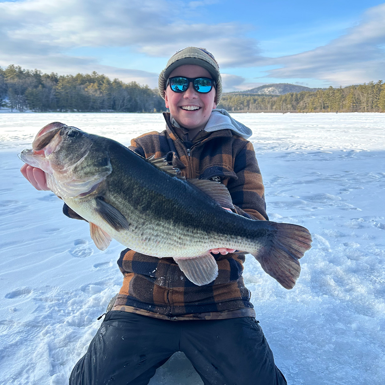 A 13-year-old angler holds up a giant Massachusetts bass.