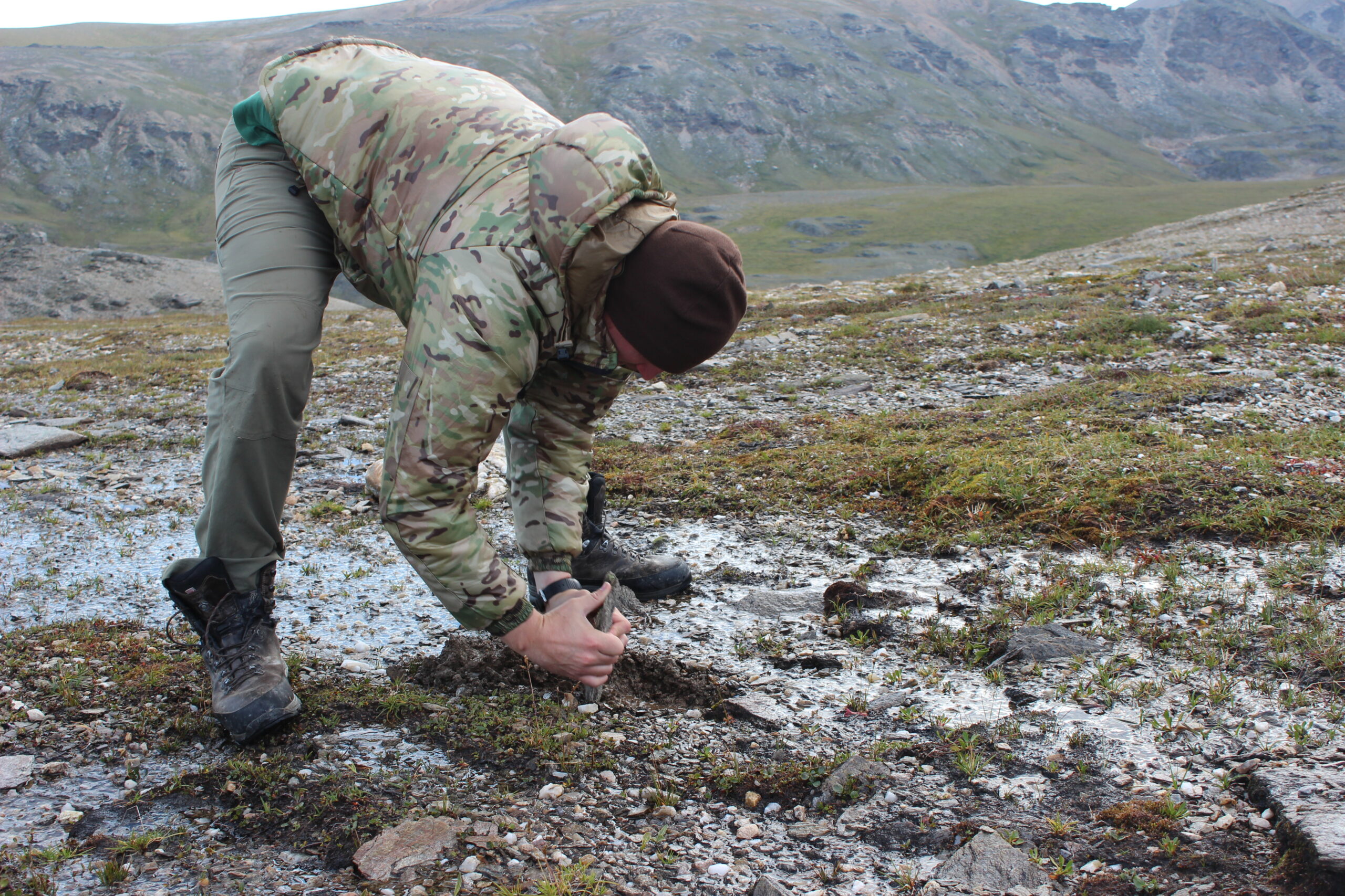 Freel digs into a seep to collect water