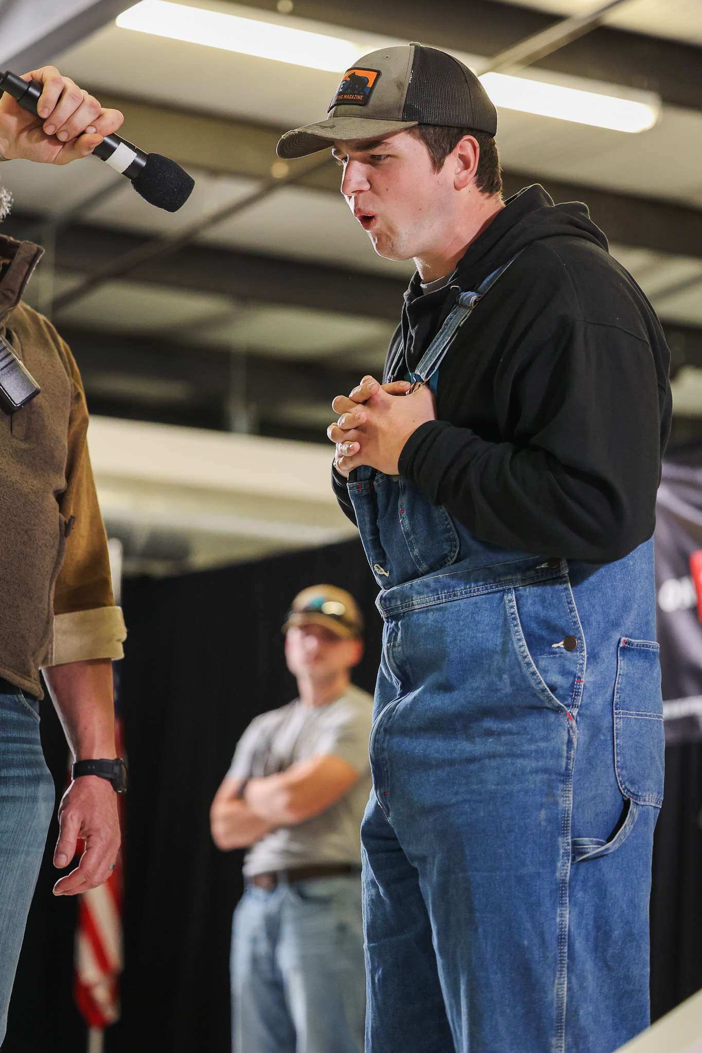 A man owl hoots into a microphone.