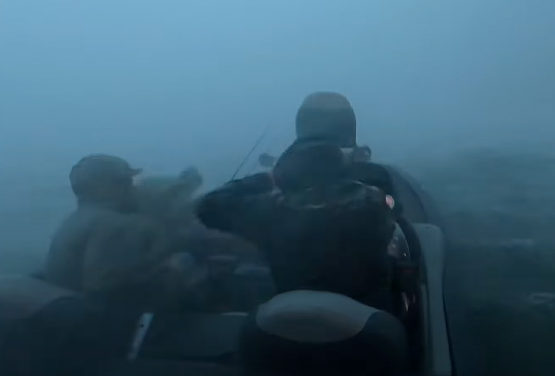 Two anglers ride their boat into a storm.