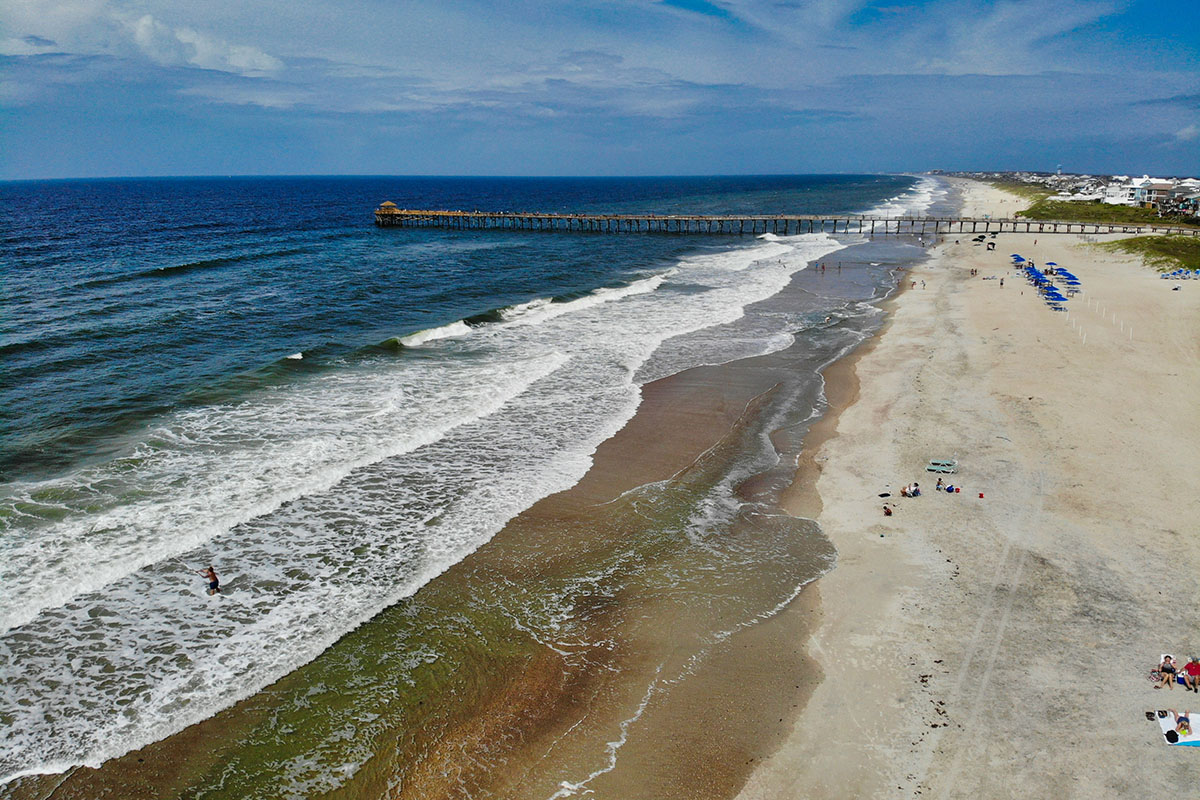 Long stretch of coastline from aerial perspective.