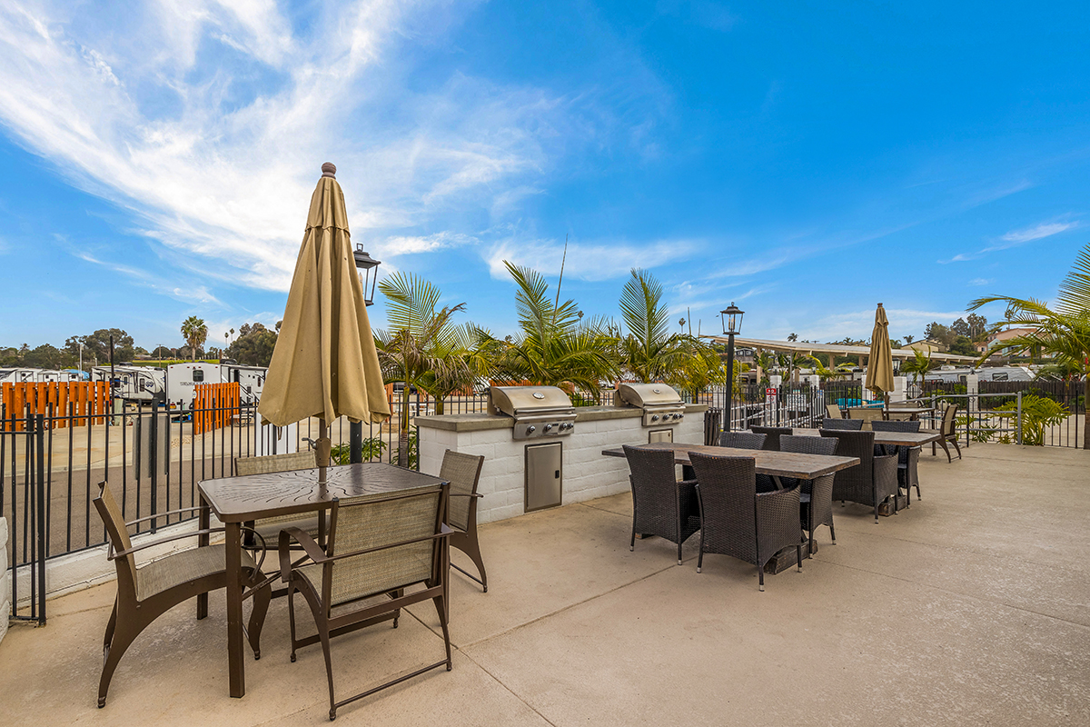 Tables and barbecue grills arrayed on a patio.