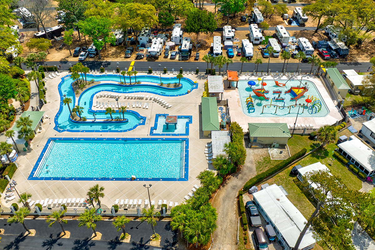 Aerial shot of rectangular pool, splash pad and lazy river.