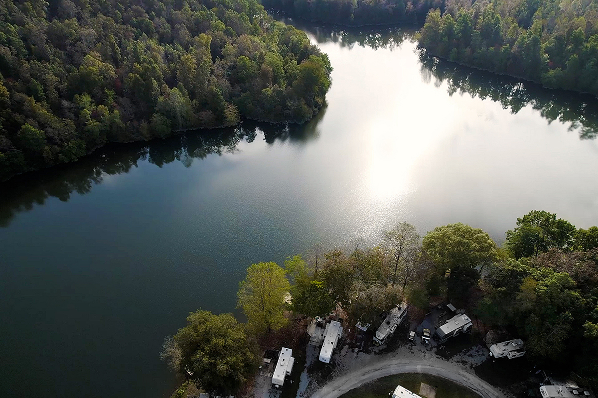 Aerial shot of RV park on banks of beautiful lake.