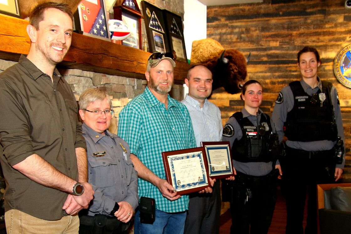 Two men receive an ethical hunter award
