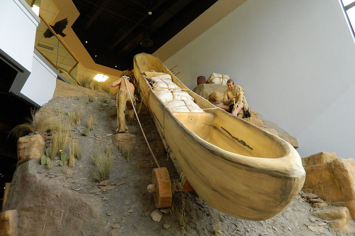 A diorama showing explorers hauling a boat.