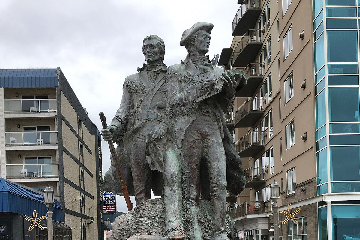 A bronze statue amid hotels.