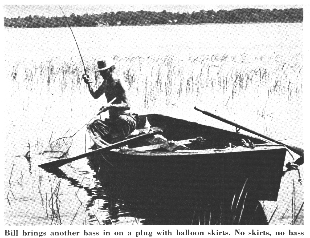 A fisherman brings a bass to the boat in an old black and white photo