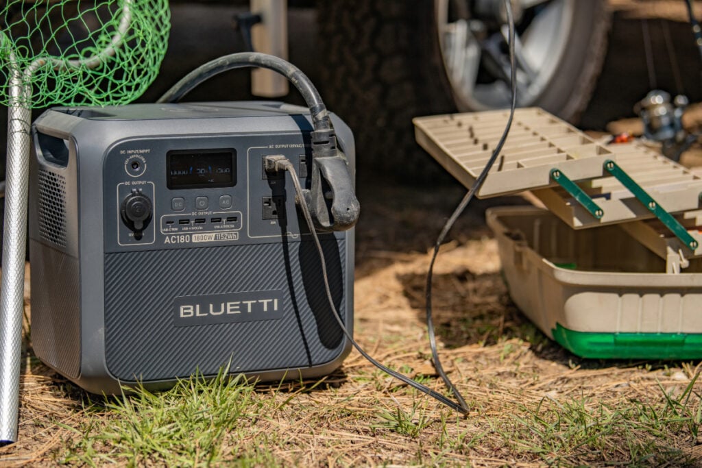 devices plugged into portable power station and tackle box set next to it