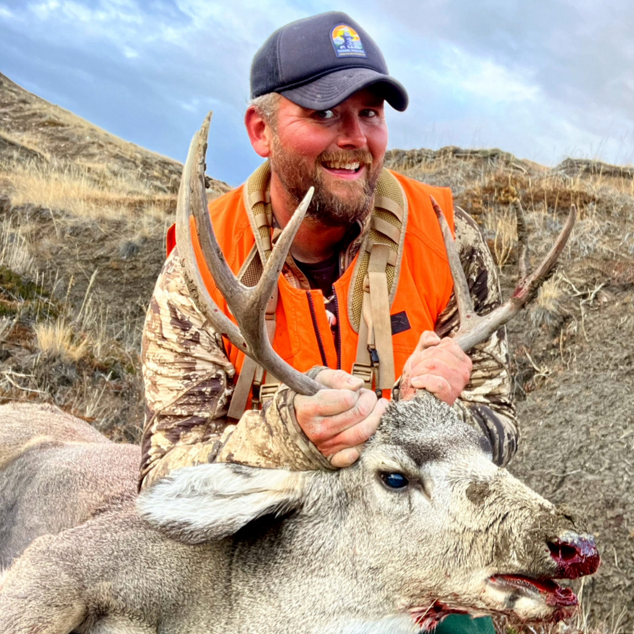 A mule deer hunter with a 3x3 buck.
