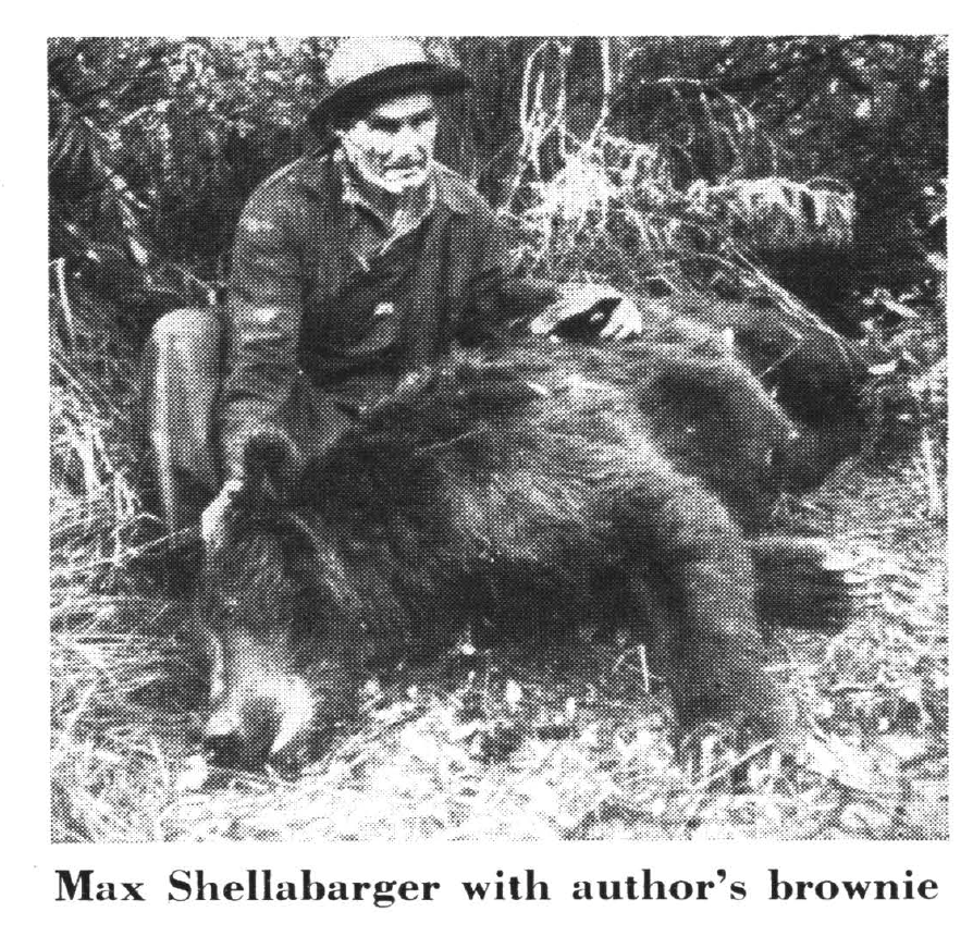 A hunter beside a bear in a black and white photo