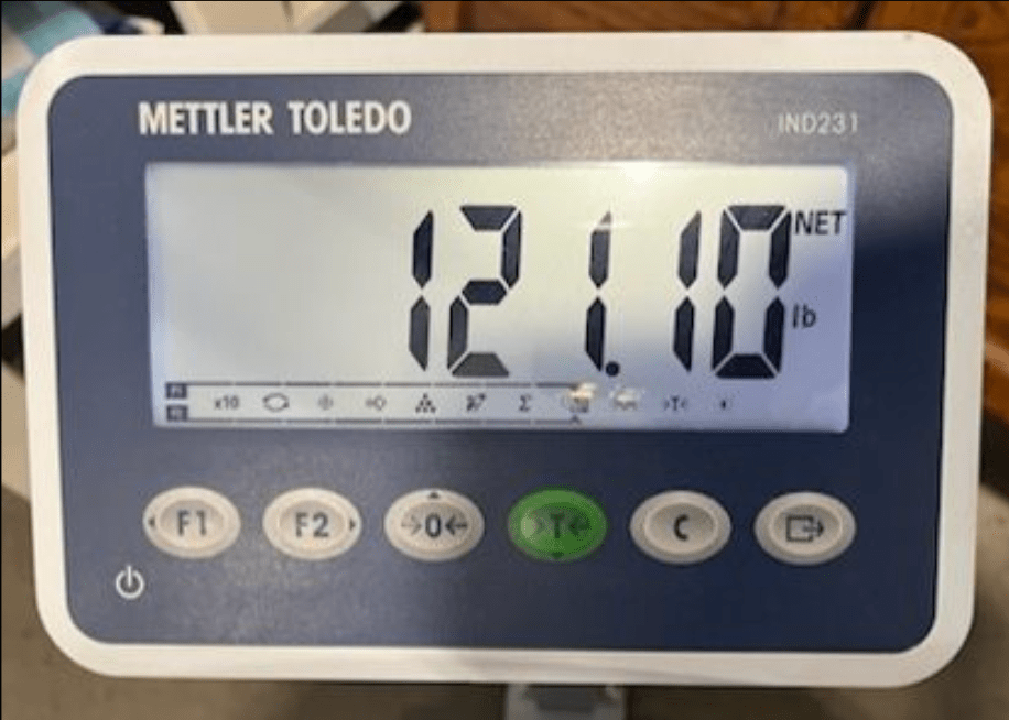 A scale that reads 121.10