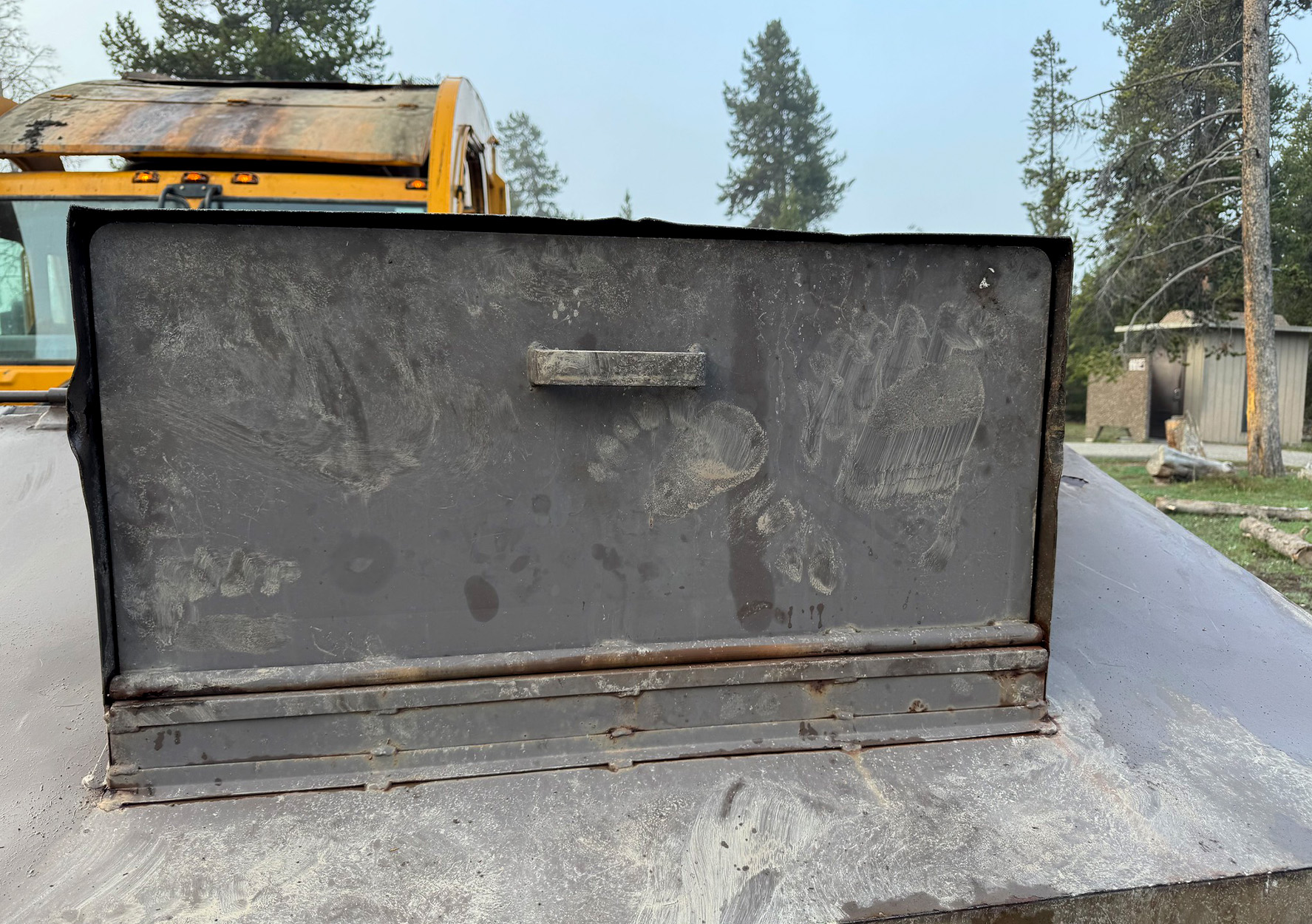 A dumpster overturned by a bear.