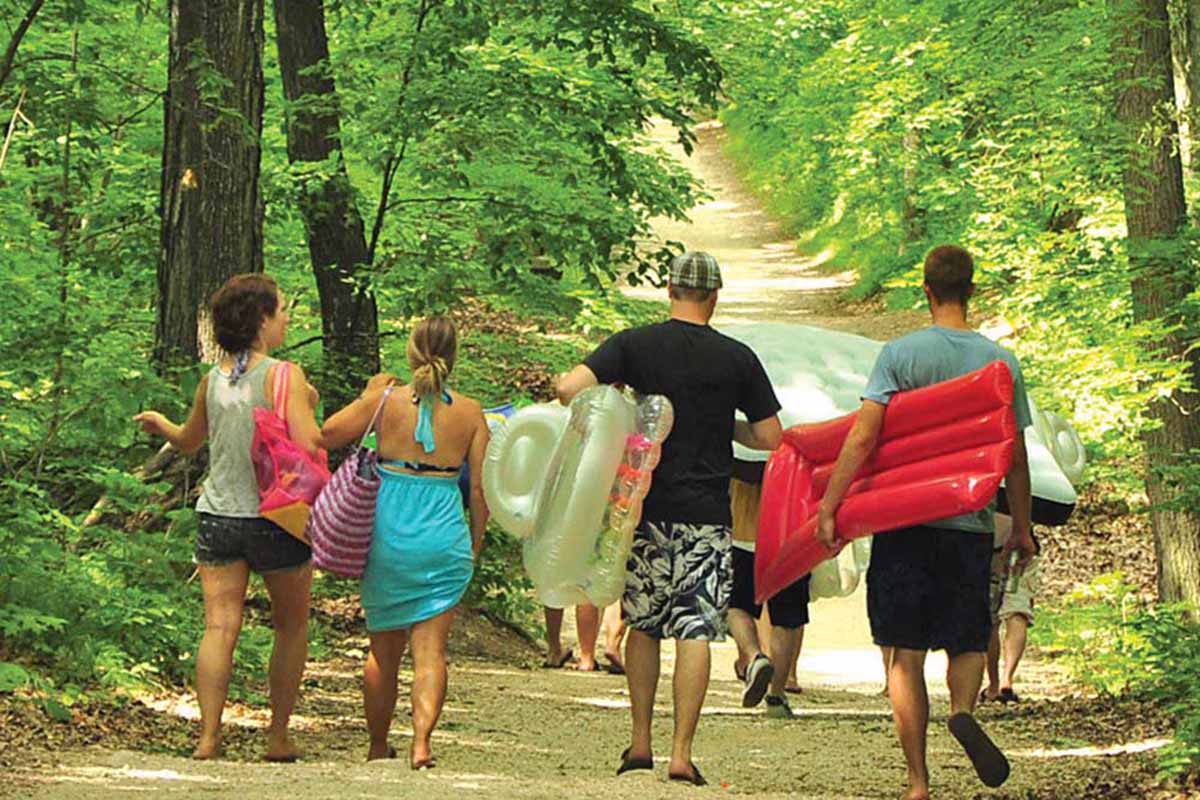 Bathers walking down a trail.