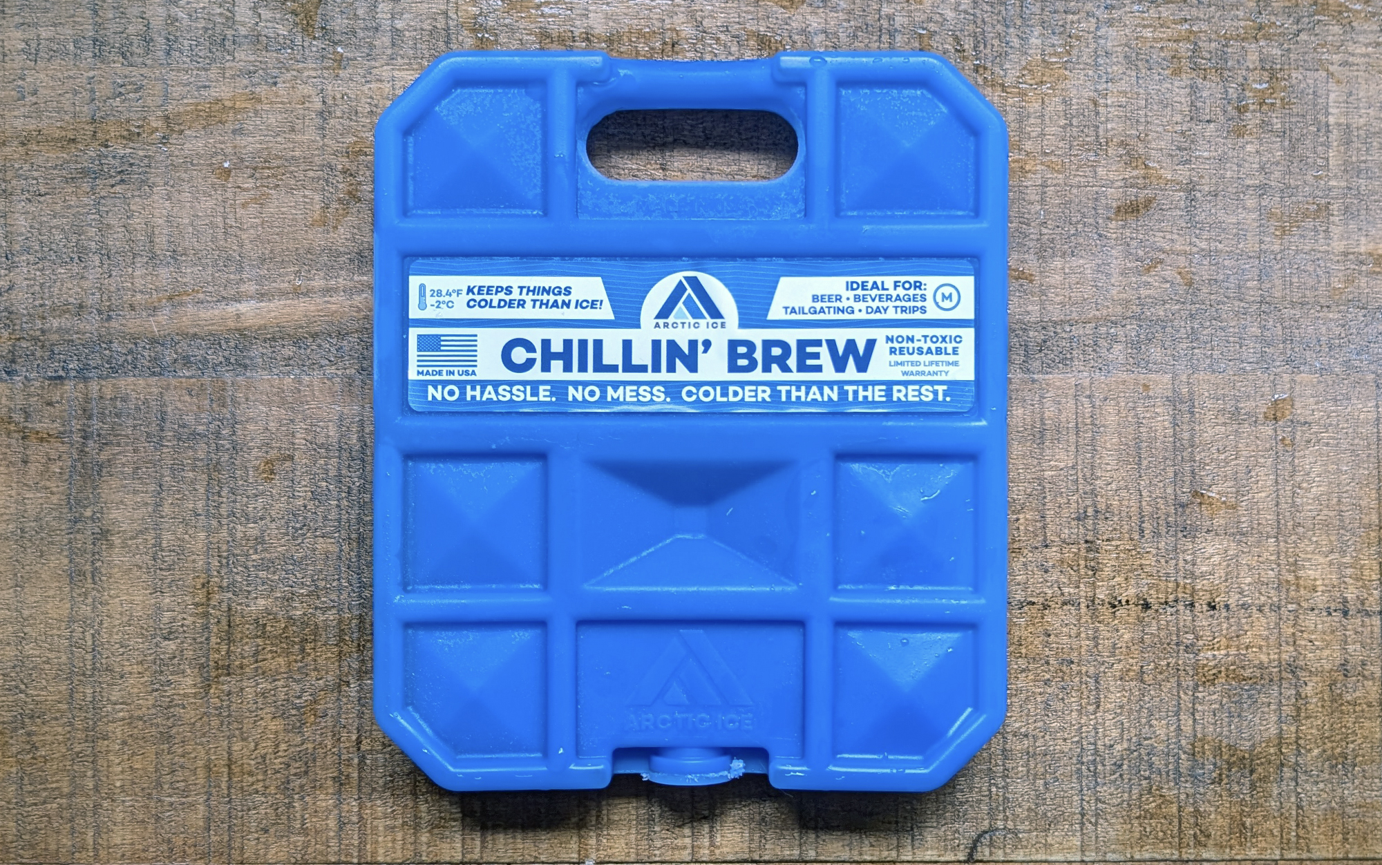  Arctic Ice chillin' brew ice packs for coolers sitting on a wooden surface