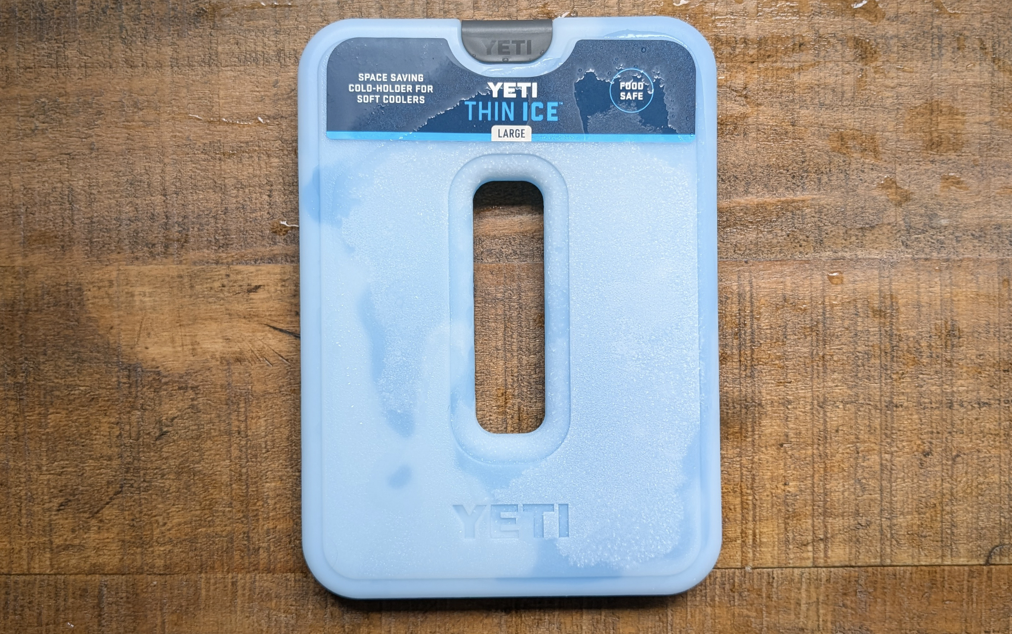  Yeti Thin Ice packs for coolers sitting on a wooden surface