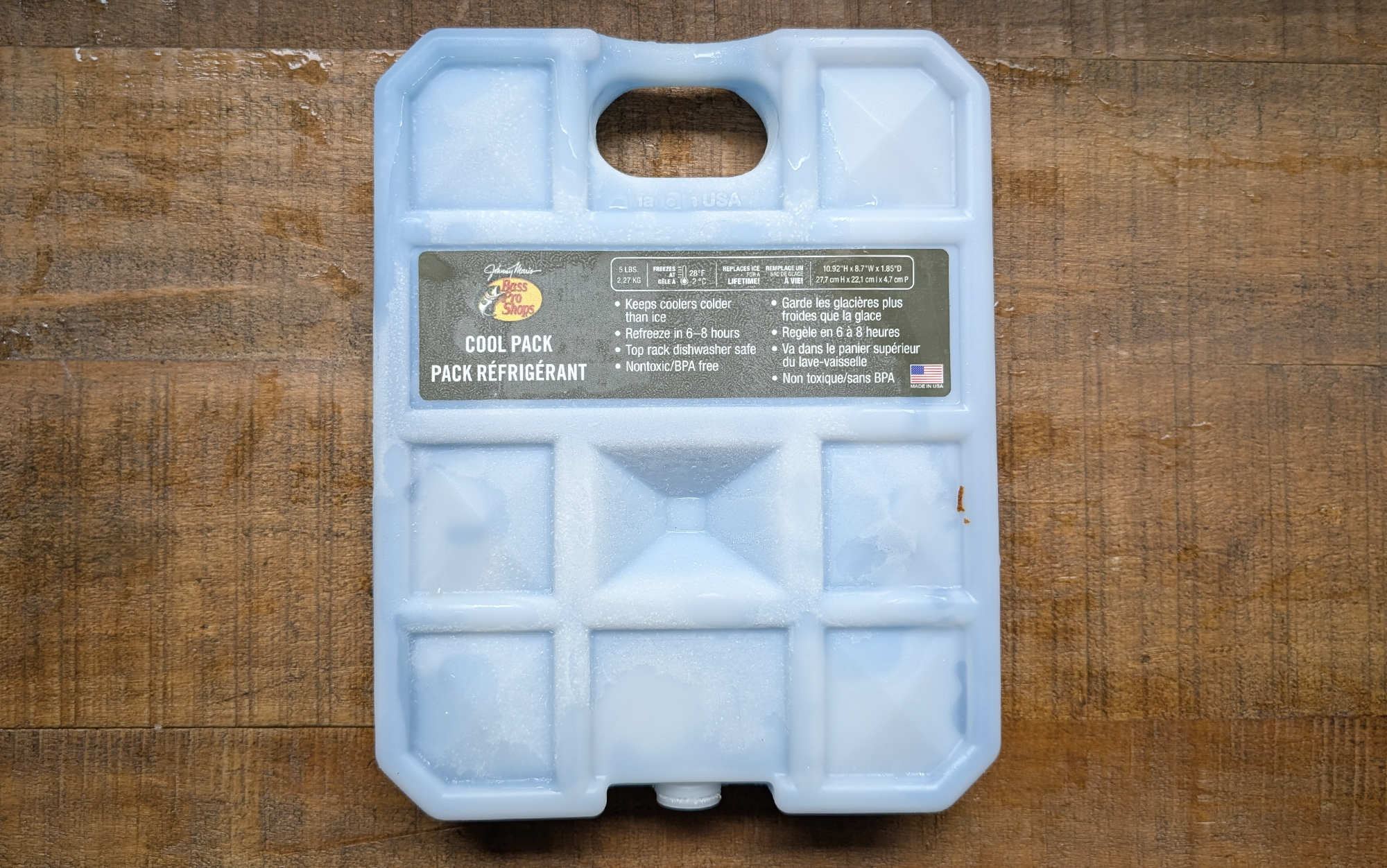  Bass Pro Shops cool pack sitting on a wooden surface
