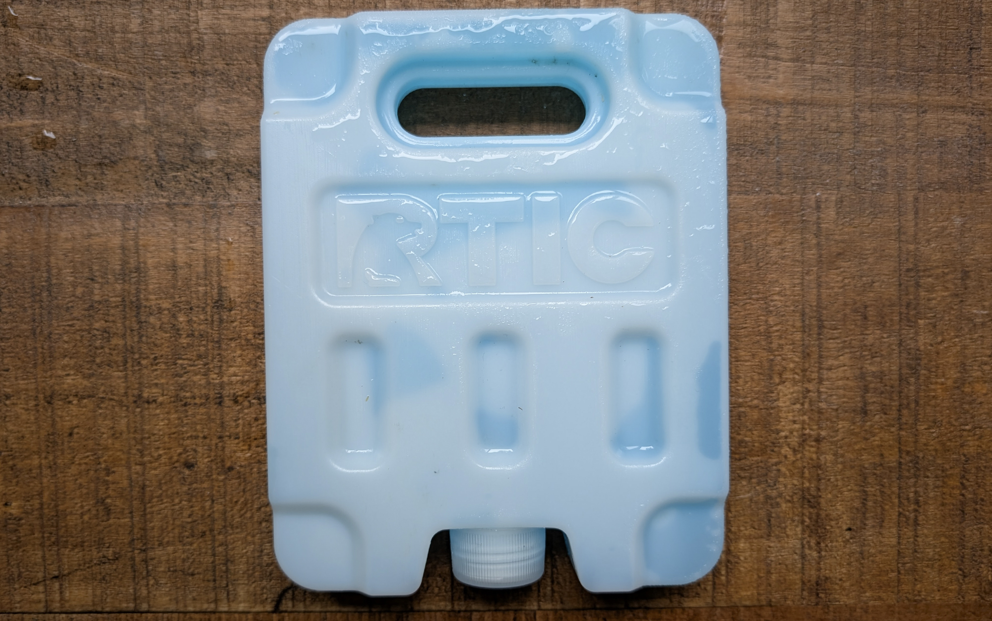 RTIC ice packs for coolers sitting on a wooden table