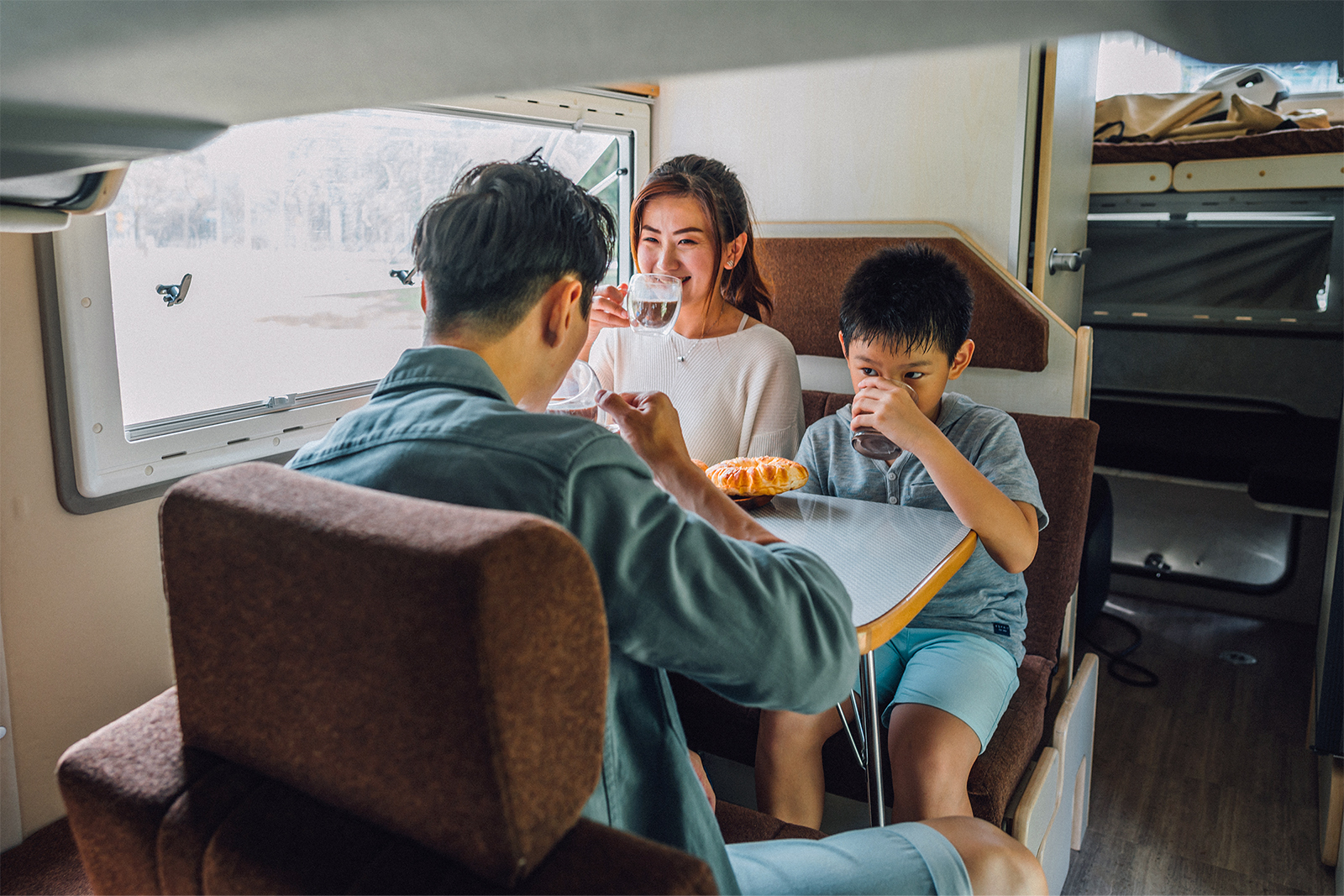 Family at campervan kitchen table